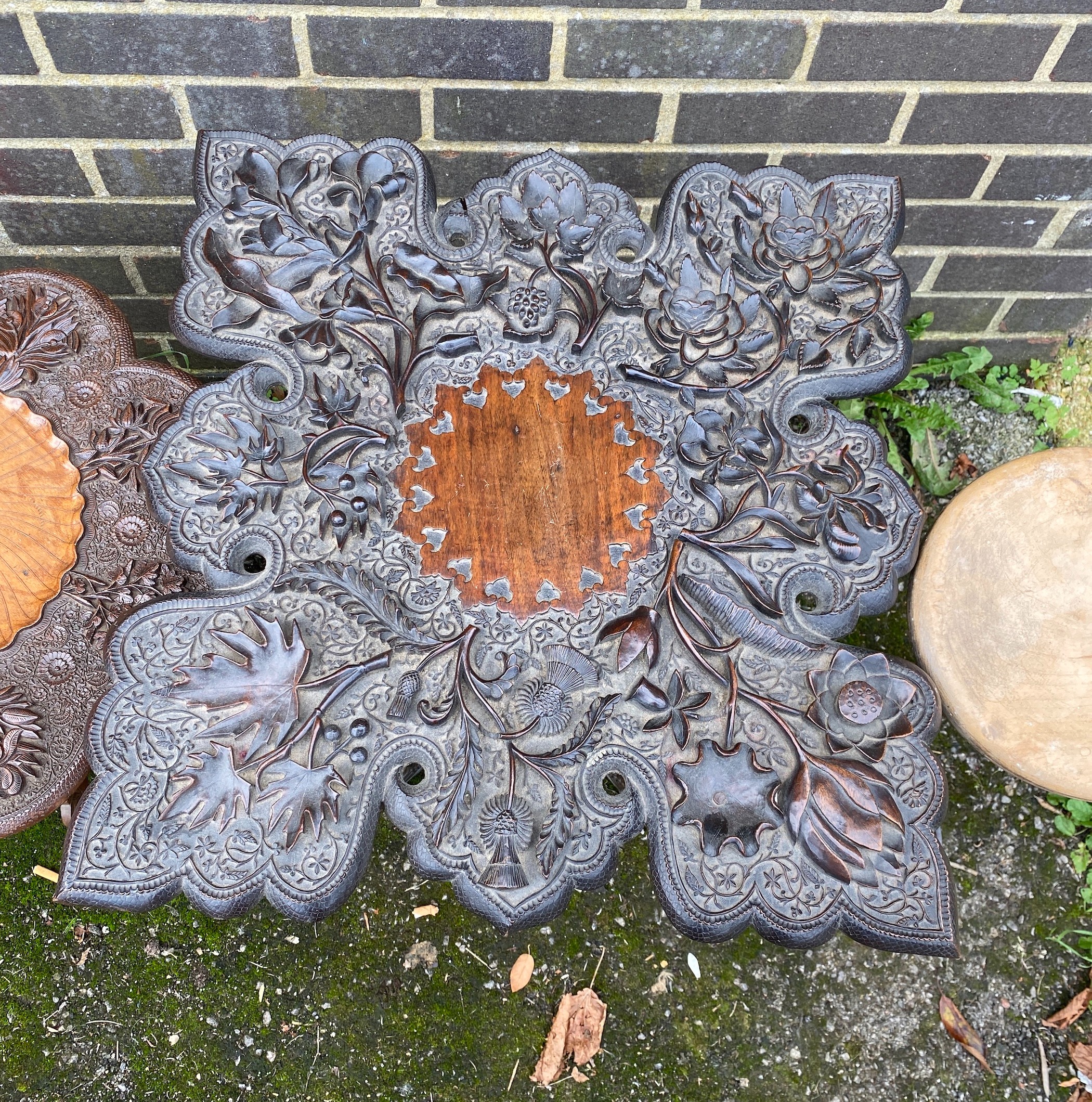 Two Indian carved hardwood occasional tables, a Victorian ebonised corner wall bracket and an industrial stool